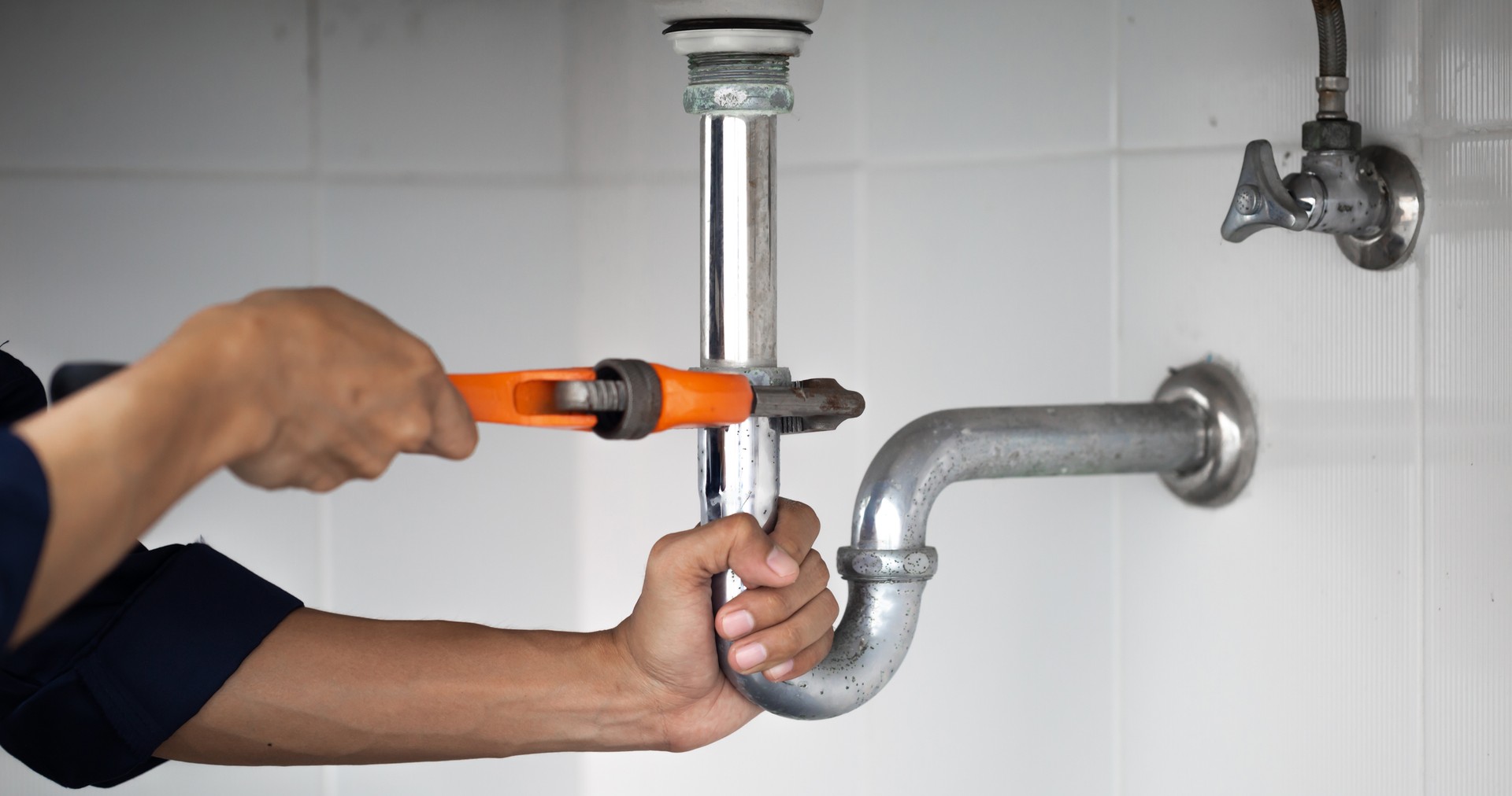 plumber at work in a bathroom, plumbing repair service, assemble and install concept.